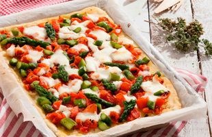 Rice and potato pizza with mozzarella, tomatoes and asparagus